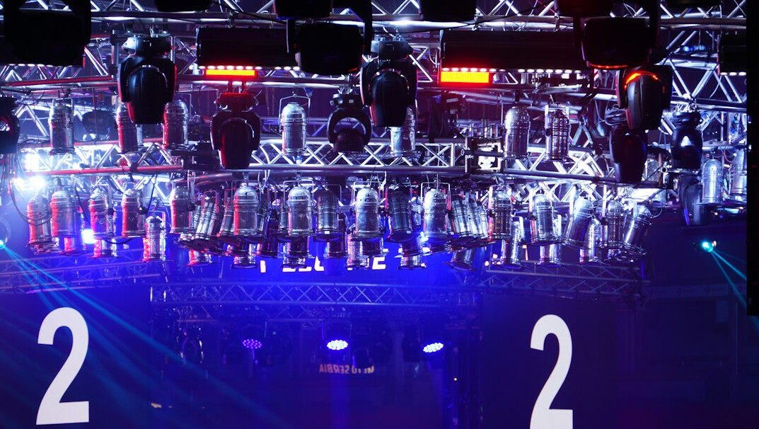 Live event stage with lighting rigs and camera positions